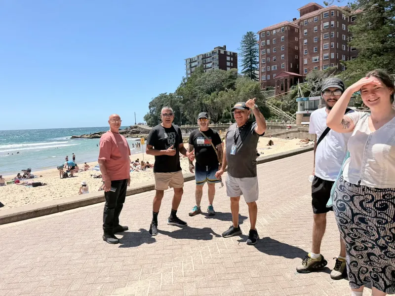 Participants and workers on the beachfront promenade on a sunny rec group outing