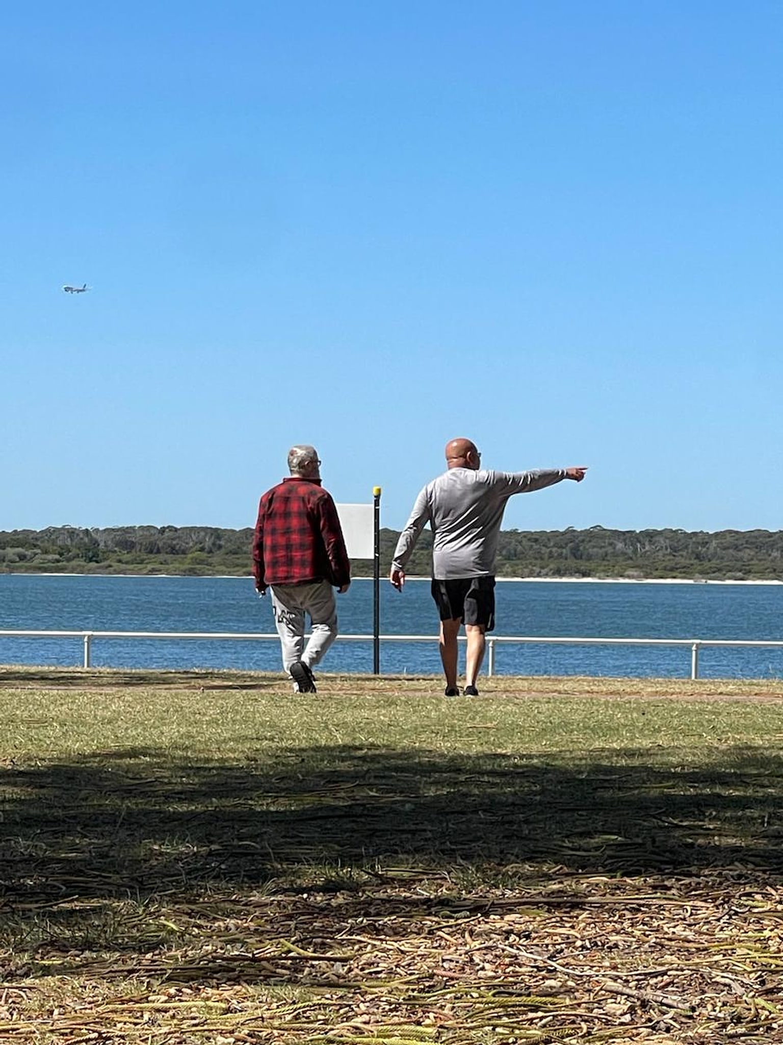 An NDIS participant and Tegrity Services support worker walking by the water in South-West Sydney