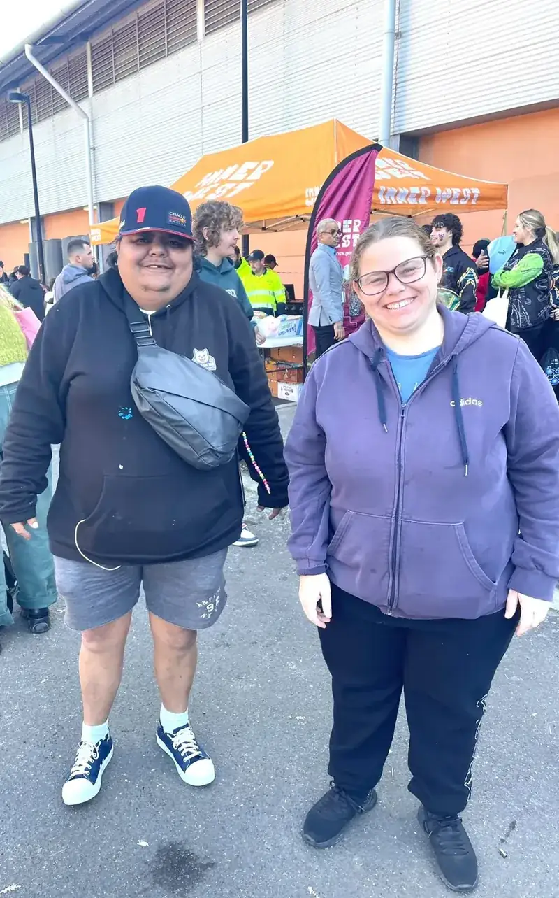 Two participants smiling together at an Inner West community event