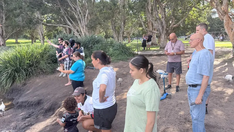 Participants and support workers gathered together in a Sydney park