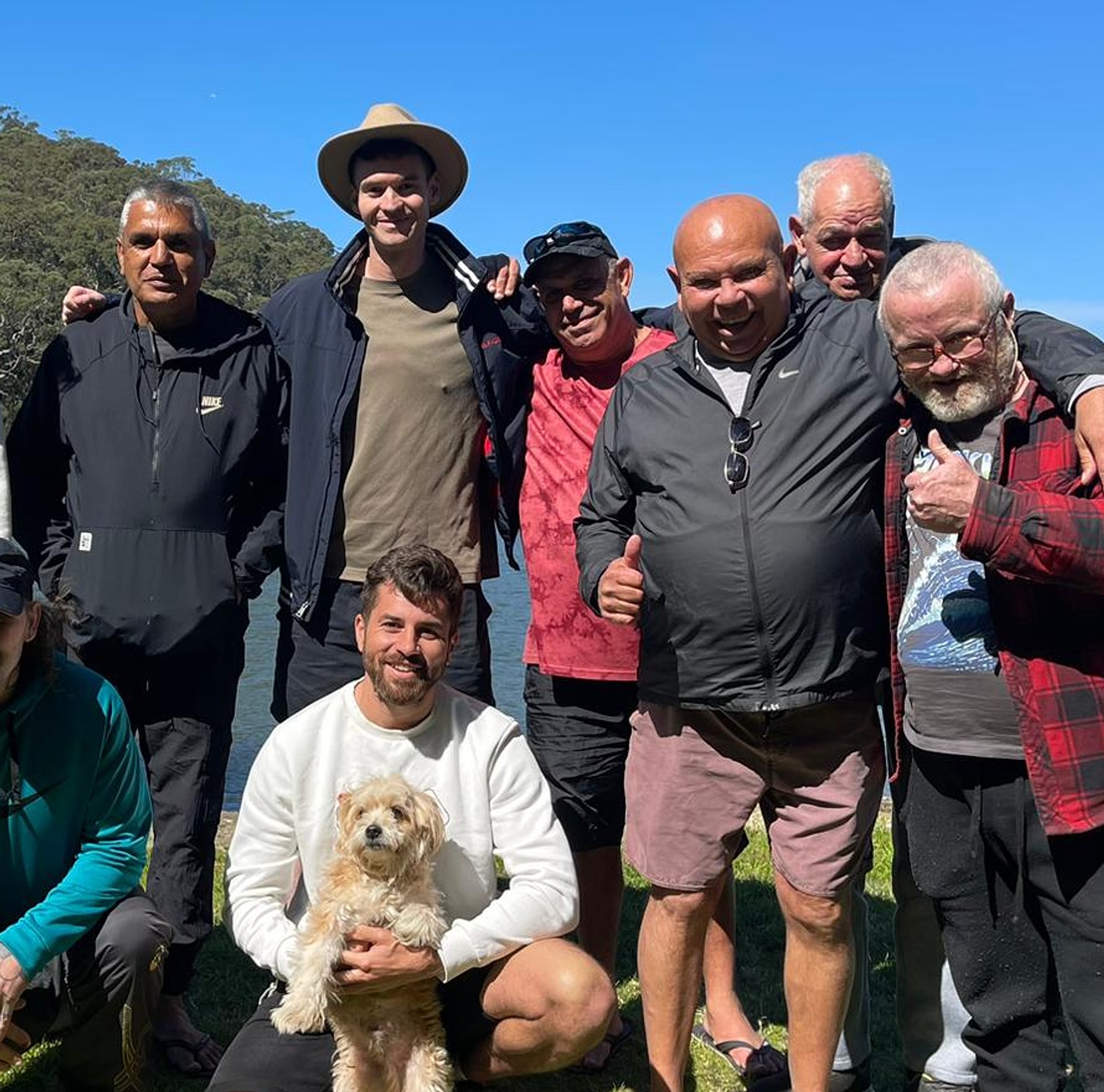 The Wednesday rec group on a riverside outing near Revesby, one member holding the group's dog