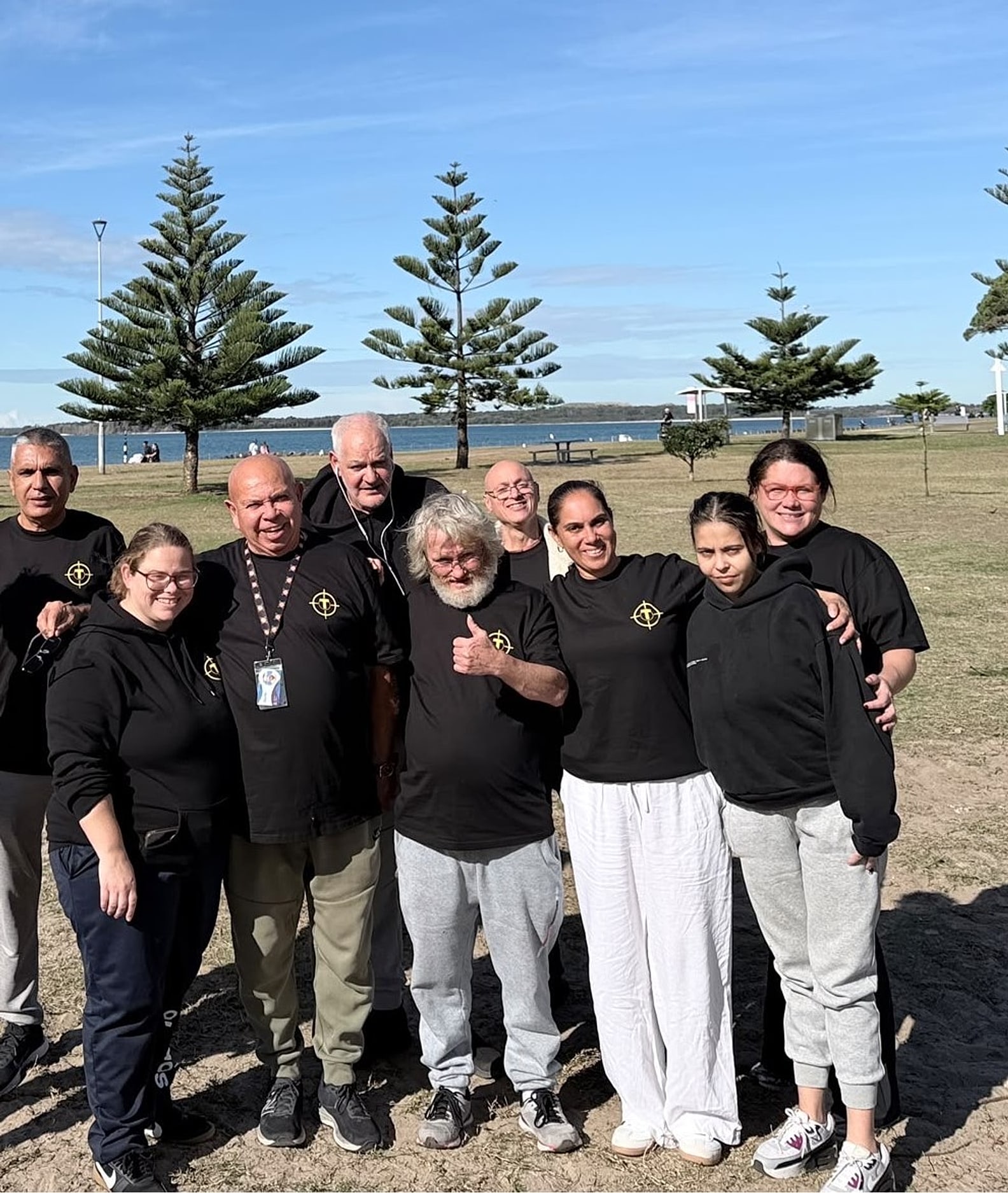 The Tegrity team in branded shirts by the water at Sans Souci