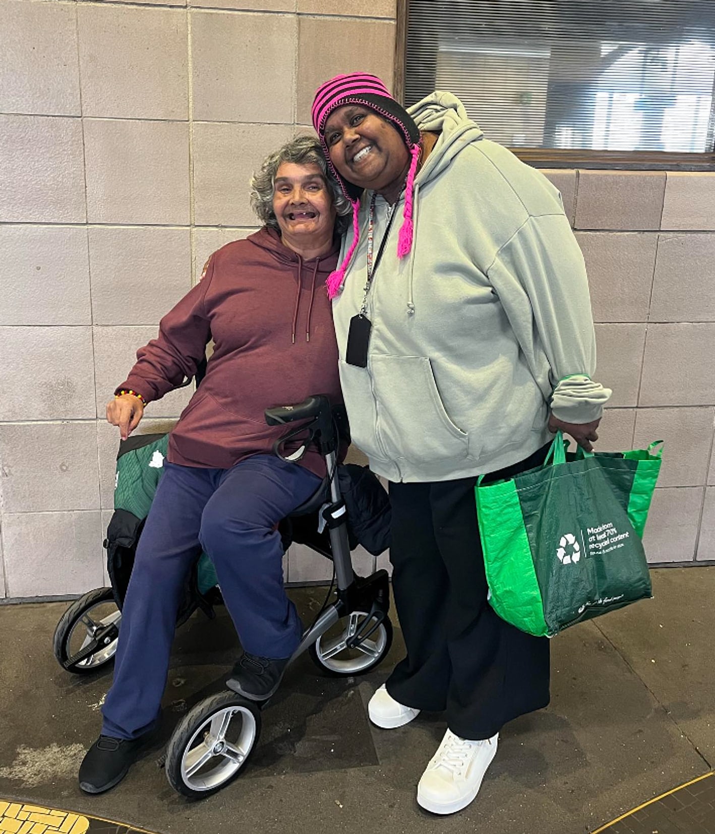 A Tegrity support worker and NDIS participant sharing a hug at a South-West Sydney station